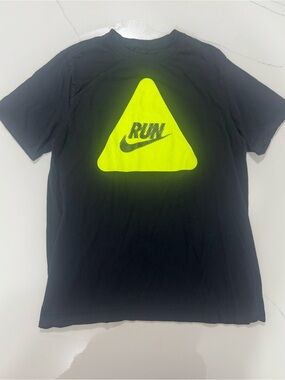 Nike “RUN” graphic t-shirt featuring a bold neon yellow triangle logo print.
